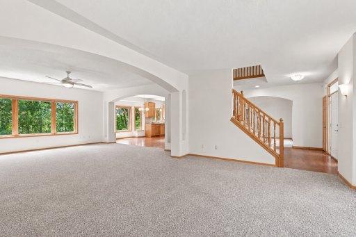 Spacious family room connects seamlessly to the foyer and kitchen, highlighting the open floor plan and custom MacDonald design.