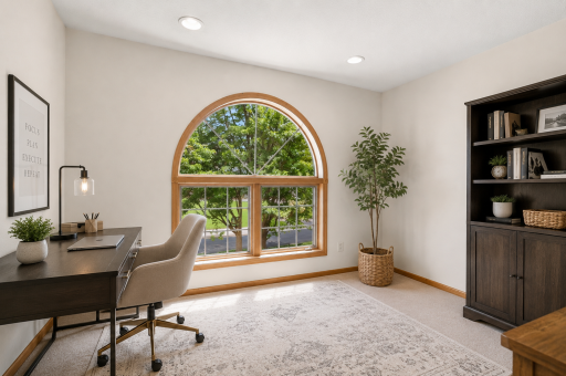 Private office with oversized arched window and beautiful natural light.