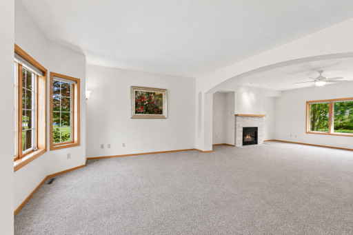 Open-concept family room offers generous living space, oversized windows, and a cozy gas fireplace, perfect for entertaining.