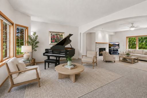 Expansive great room features oversized windows, a gas fireplace, and an open layout overlooking the private wooded backyard.. Virtually Staged