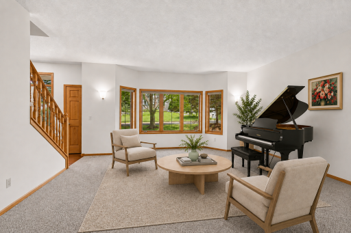 Versatile front living room with oversized windows offers the perfect space for entertaining, reading, or a piano room. virtually staged