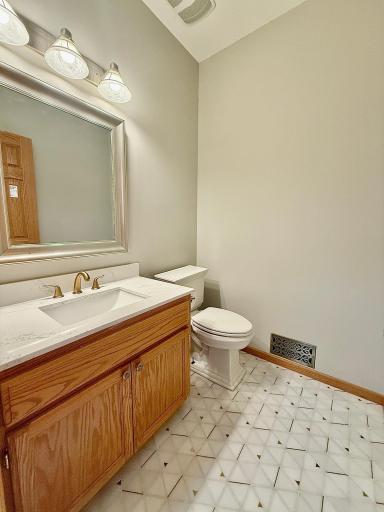Main floor 1/2 bath just remodeled with marble tile, new countertop & faucet