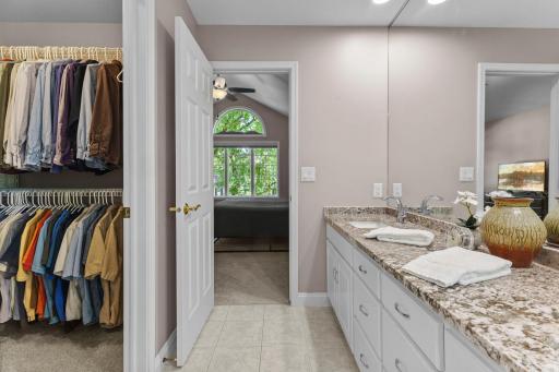 Private en suite with dual sinks, granite countertops and a walk in closet.