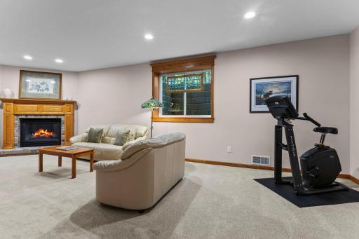 Spacious lower level recreation/family room featuring a fireplace.