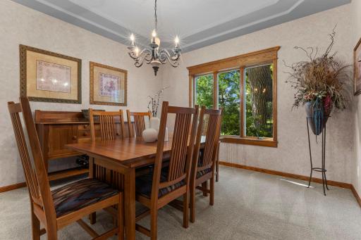Formal dining room with stunning tray ceiling and backyard views.