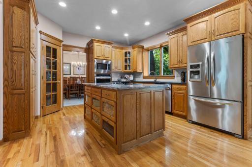 Stainless appliances and wood cabinetry anchor a kitchen built for daily use.