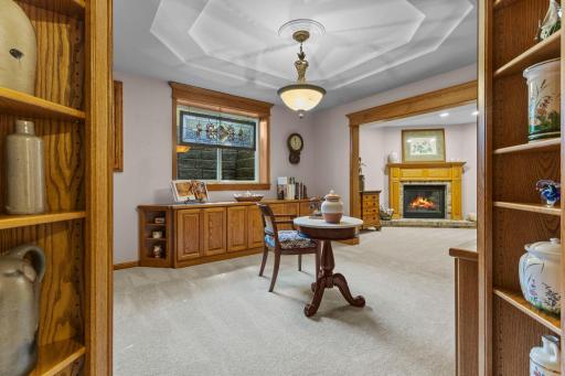 Lower level library nook tucked beneath a tray ceiling.