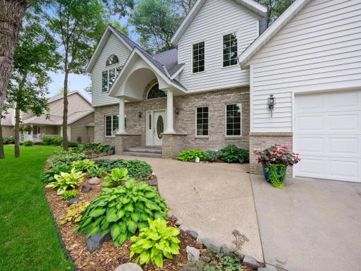 Front of the home framed by mature landscaping.