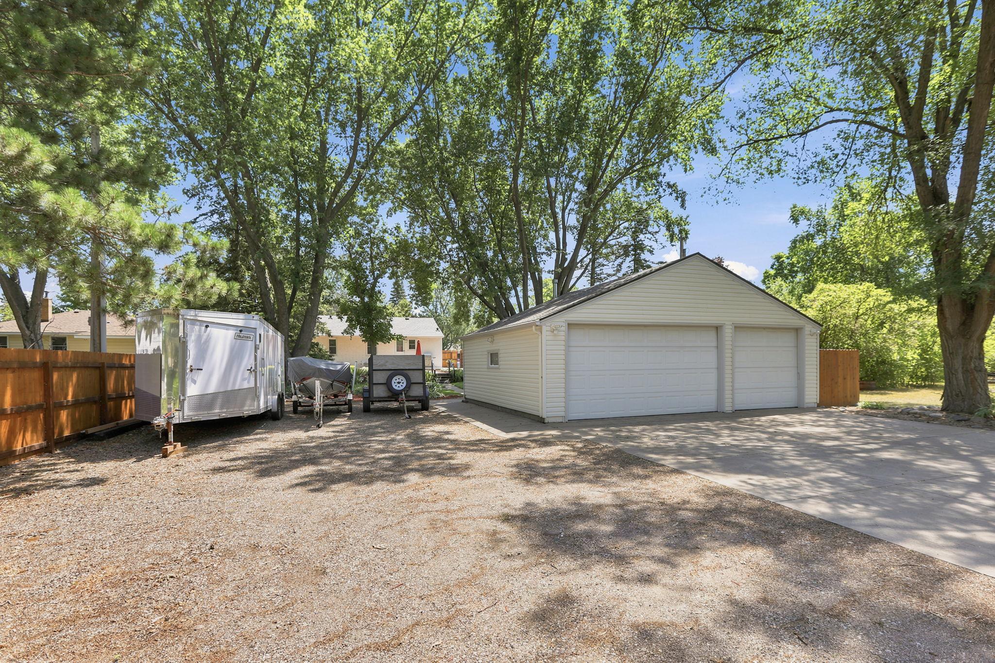 The heated, partially insulated 3-car garage with hard to find 8' tall garage doors, provides exceptional storage and workspace, while the oversized driveway offers parking for up to seven vehicles plus a trailer pad.