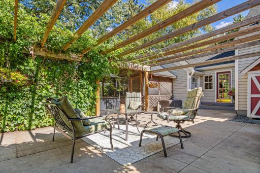 This magical backyard has a little something for everyone. The large patio has a darling pergola that is beautiful all year round, but especially beautiful when the Wisteria and Trumpet Flower vines are in full bloom.