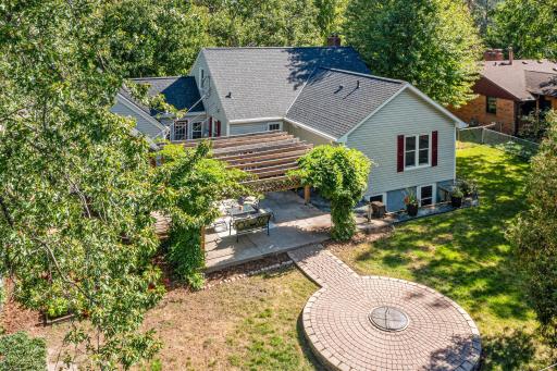 This aerial view highlights an extension that was added in the early 2000's to add significant space to this home's original footprint. The addition created a main floor primary bedroom suite and 2 additonal legal bedrooms in the lower level.