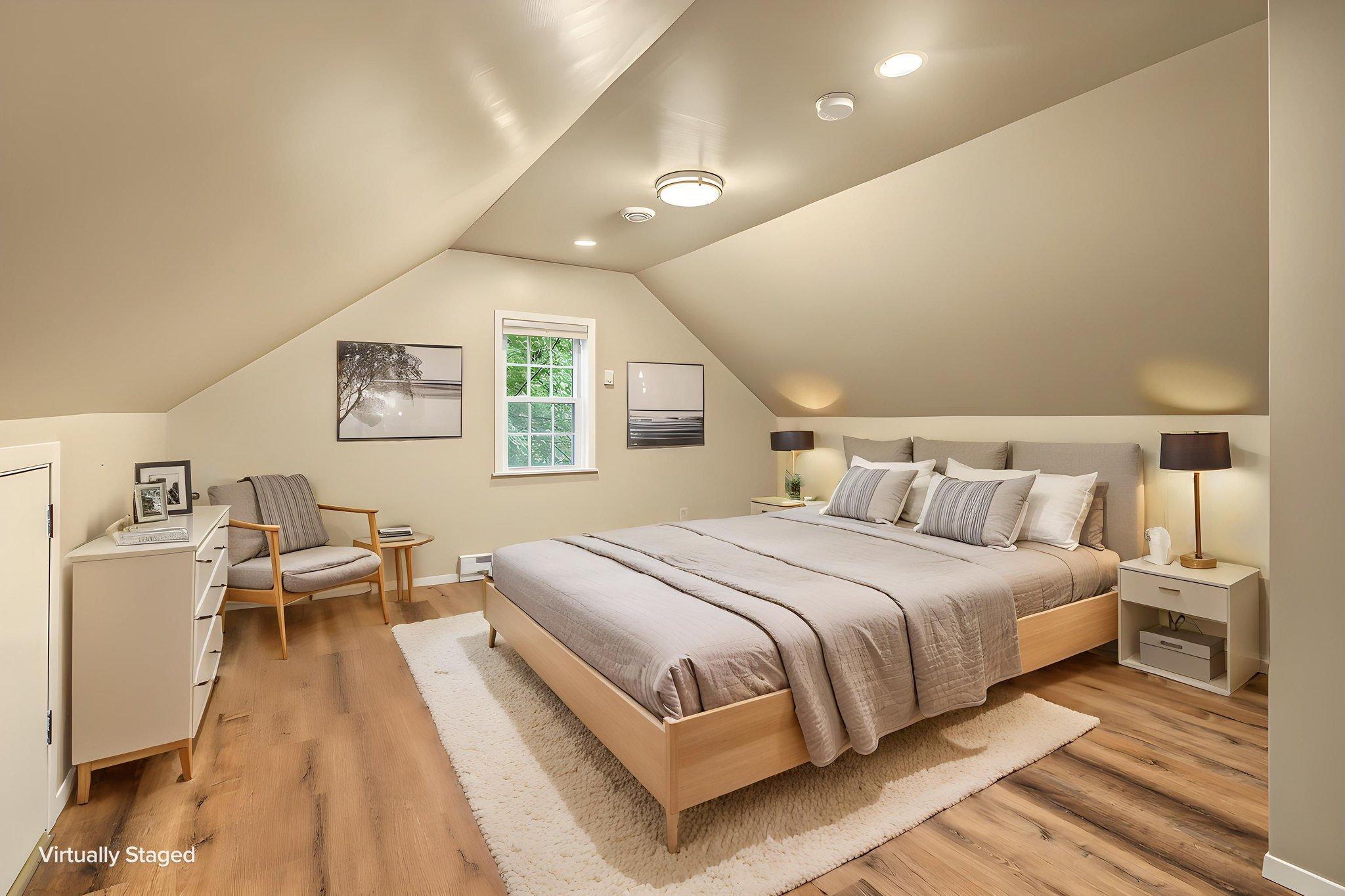The upper level was recently refinished! This room features new LVP flooring, fresh paint, recessed lighting, a soothing paint scheme, a full sized closet and unusually high ceilings for a 1.5 story home! Photo is virtually staged to show potential.