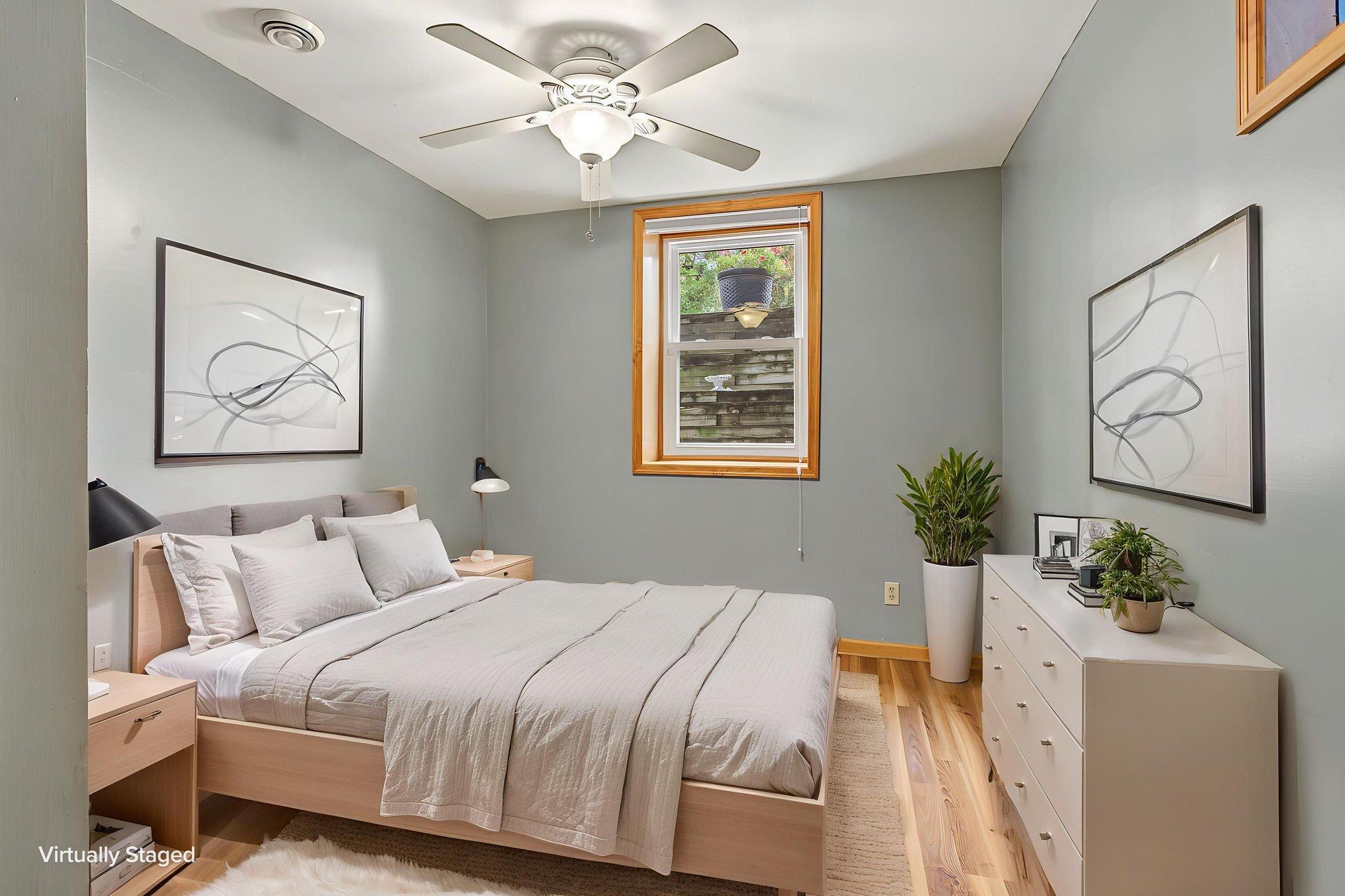 Lower level bedroom 1 of 2. The owners chose to dig down an extra foot when the addition was added so the ceilings are nearly 8 foot in here. Room has been digitally staged to show potential.