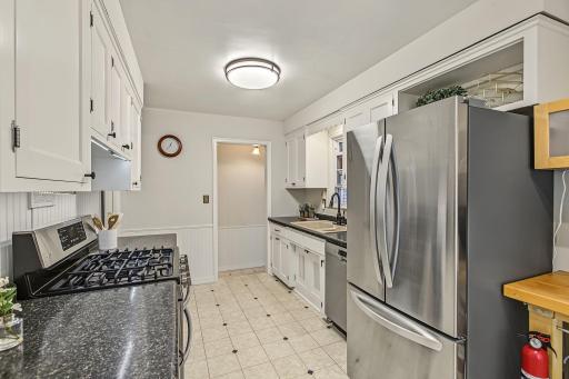Alternate view of the kitchen toward the hallway that leads to the sunroom/mudroom and lower level.
