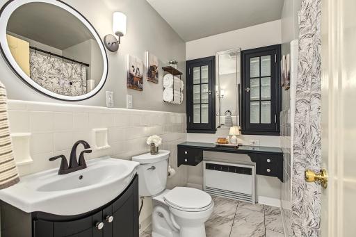 The 2nd main floor bath is a fabulous mix of vintage charm and modern style. This room has been updated for today's needs, but retained some of the original details that make it feel special.