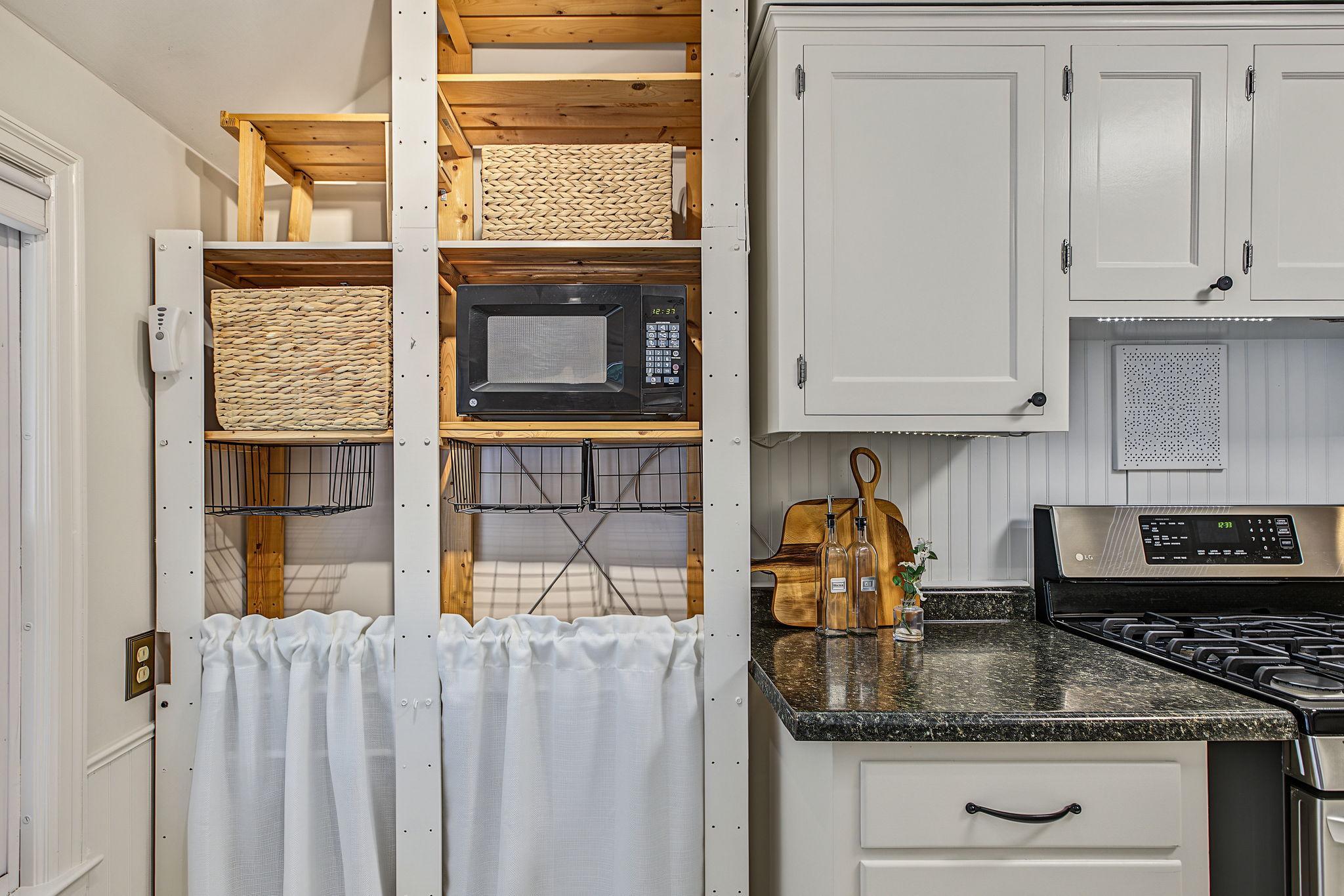 The current owners added some clever storage, but additional cabinetry could be added too! This would be an excellent spot for a full length pantry. The layout of the dining room and kitchen would allow a new homeowner to create an open plan too.