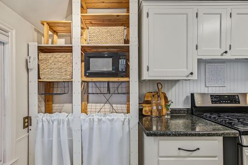 The current owners added some clever storage, but additional cabinetry could be added too! This would be an excellent spot for a full length pantry. The layout of the dining room and kitchen would allow a new homeowner to create an open plan too.