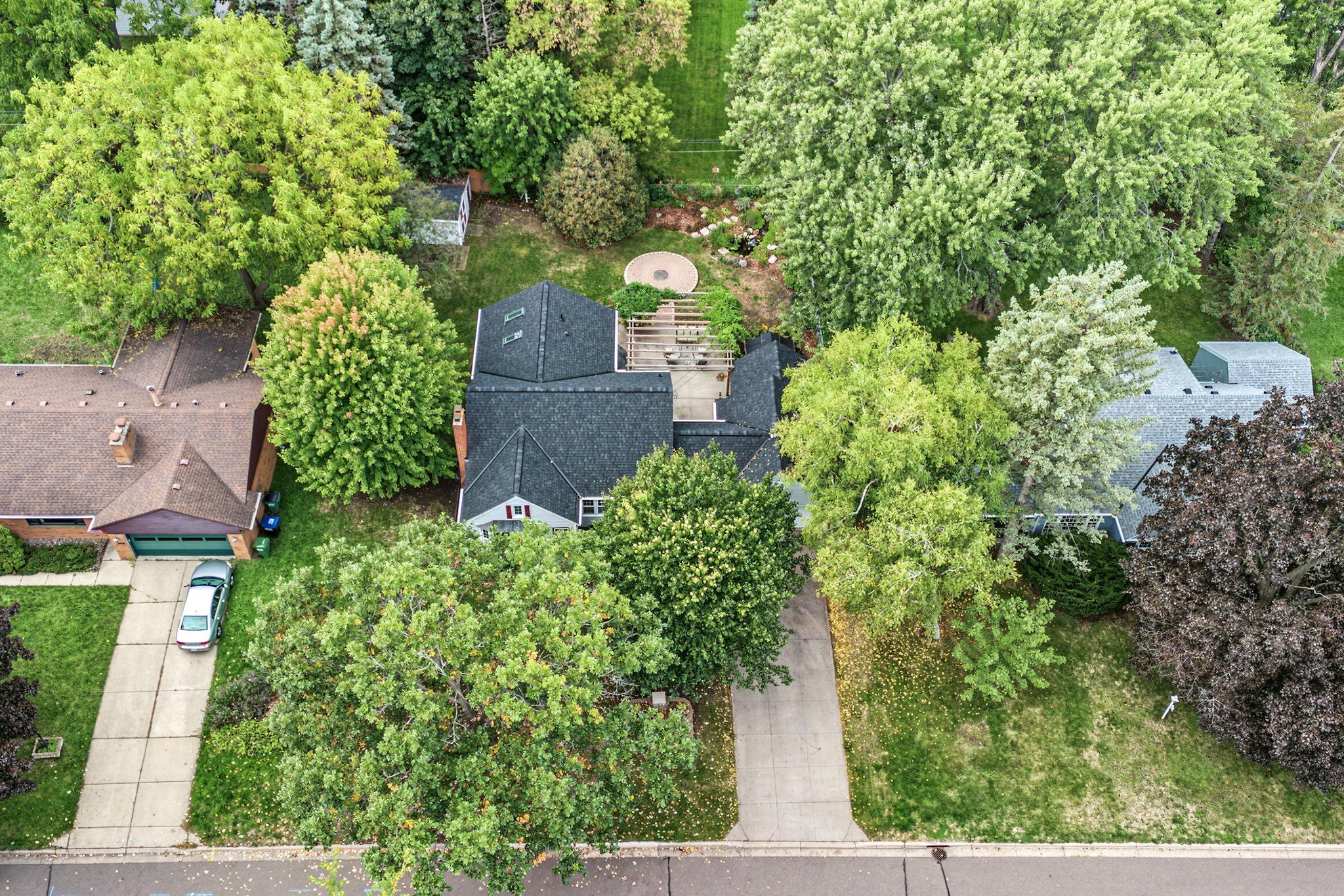 Aerial view showcases the size of the home and property. This neighborhood has tons of mature trees too!