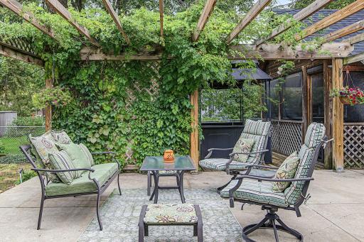 The yard has a spacious patio with a pergola and trellis covered in Wisteria and Trumpet Flowers. The vines are always pretty, but they are especially lovely when in full bloom.