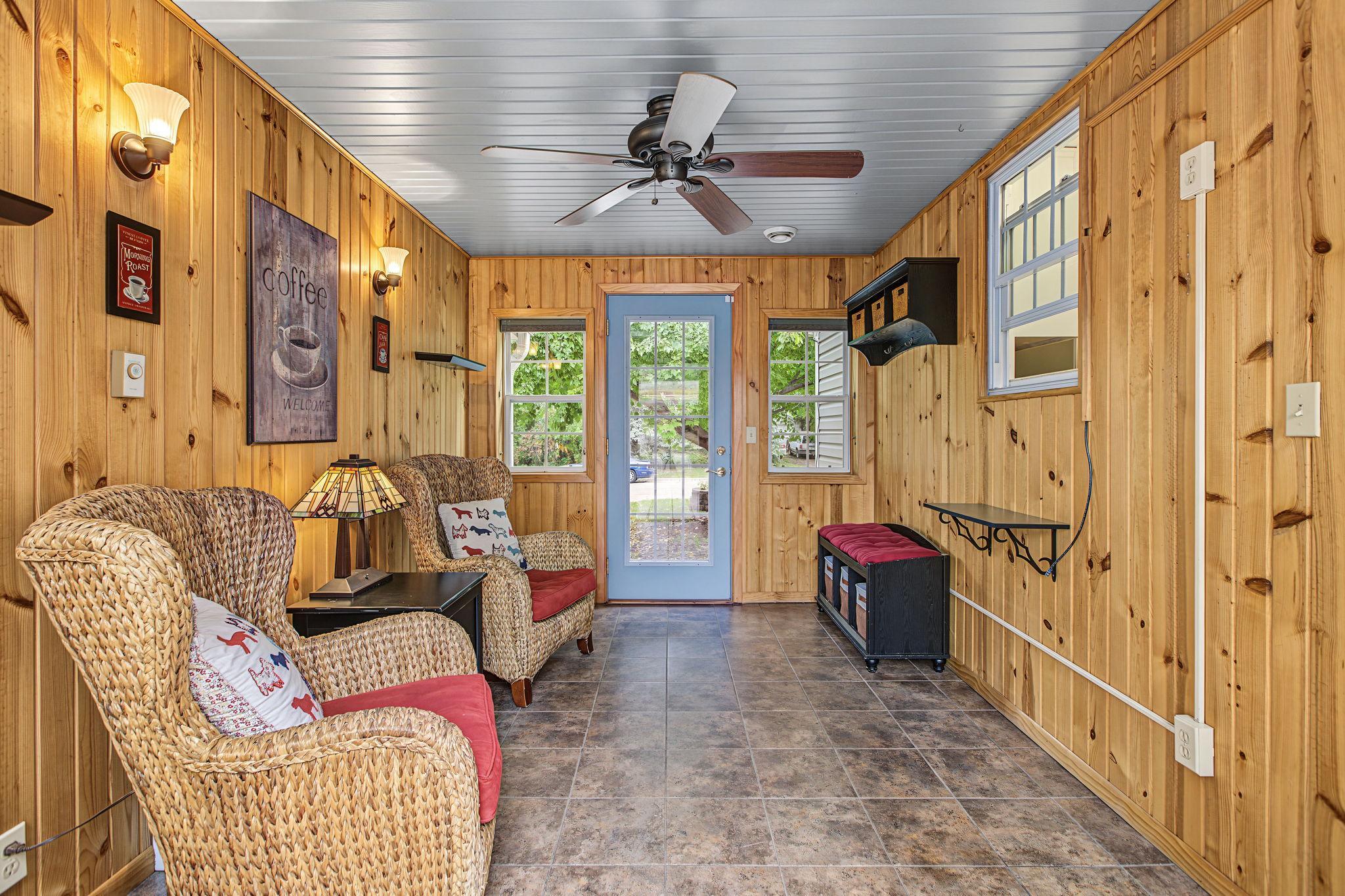 The breezeway was converted to a 4 season porch and has access to the front yard as well as the back yard. This room would make a fantastic mudroom or could be converted to main floor laundry since plumbing is on the adjacent kitchen wall.