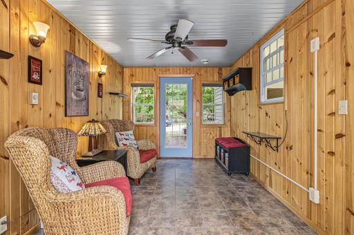 The breezeway was converted to a 4 season porch and has access to the front yard as well as the back yard. This room would make a fantastic mudroom or could be converted to main floor laundry since plumbing is on the adjacent kitchen wall.