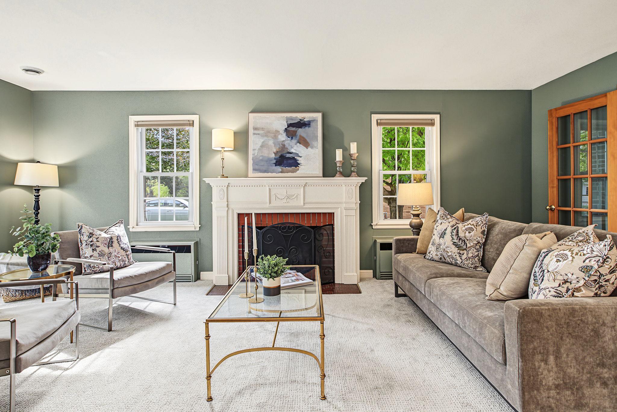 Timeless elegance meets modern living in this beautiful living room. You will want to linger here and enjoy the serene atmosphere. Soothing green walls invite the outdoors in, the fireplace adds classic charm and the carpet is brand new!