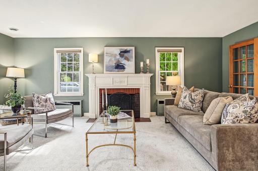 Timeless elegance meets modern living in this beautiful living room. You will want to linger here and enjoy the serene atmosphere. Soothing green walls invite the outdoors in, the fireplace adds classic charm and the carpet is brand new!