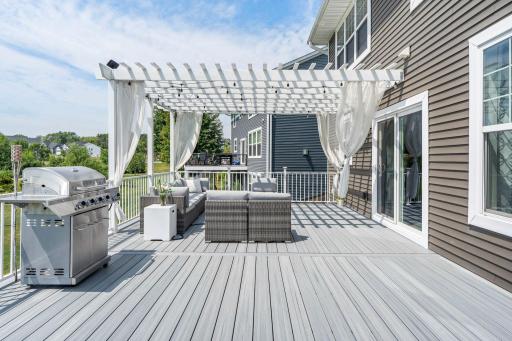 Alternate angle of the large composite deck showing sliding glass door access to the main living areas.