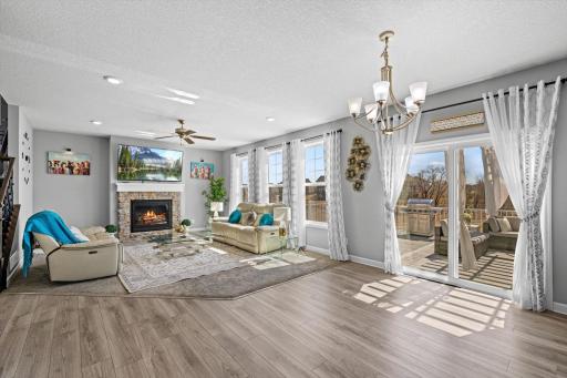 Spacious open-concept main floor connecting the living room, dining area, and walkout deck access.