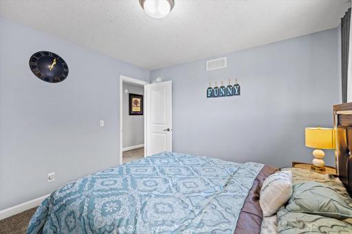 Alternate view of the bedroom highlighting the functional layout, quiet atmosphere, and adjacent hallway access.