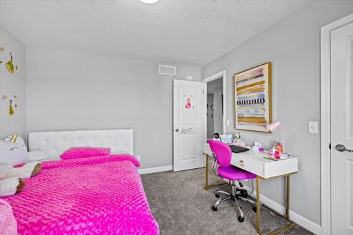 Alternate view of the bedroom highlighting the versatile layout, neutral wall tones, and generous wall space for furnishings.