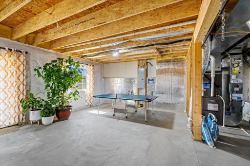 Massive lower-level space highlighting clean concrete floors, mechanical systems, walkout/window access, and ultimate storage versatility.
