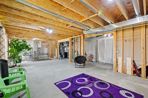 Open-concept unfinished basement offering abundant room for storage, home gym equipment, or a customized living area.