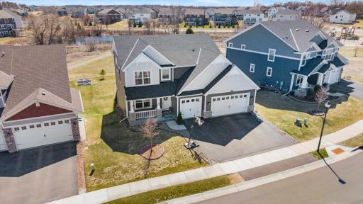 Aerial perspective highlighting the home's roofline, spacious lot placement, and surrounding neighborhood setting.