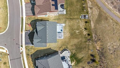 Overhead lot view displaying the property lines, deep backyard, rear deck footprint, and adjacent walking path/green space.