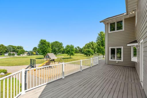 Walkout to Deck overlooking stunning backyard w/ outdoor Basketball Court & Play area