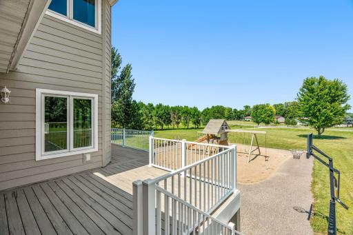 Walkout to Deck overlooking stunning backyard w/ outdoor Basketball Court & Play area