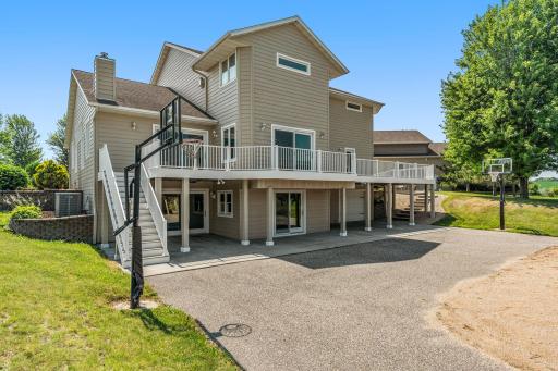 Walkout to Deck overlooking stunning backyard w/ outdoor Basketball Court & Play area