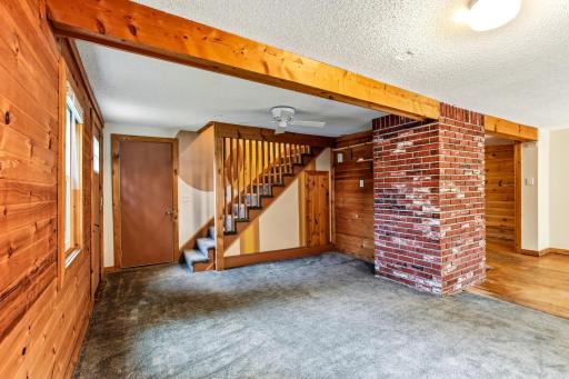 Brick wall, wood beam and unique staircase add more character