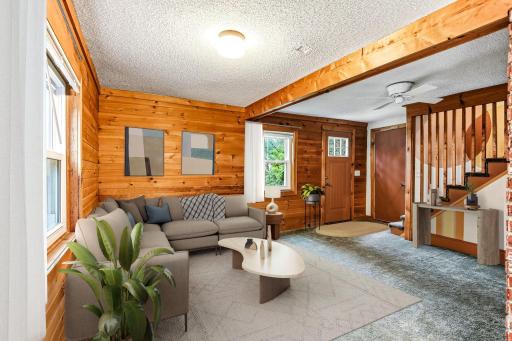 Welcoming living room with real wood walls-virtually staged