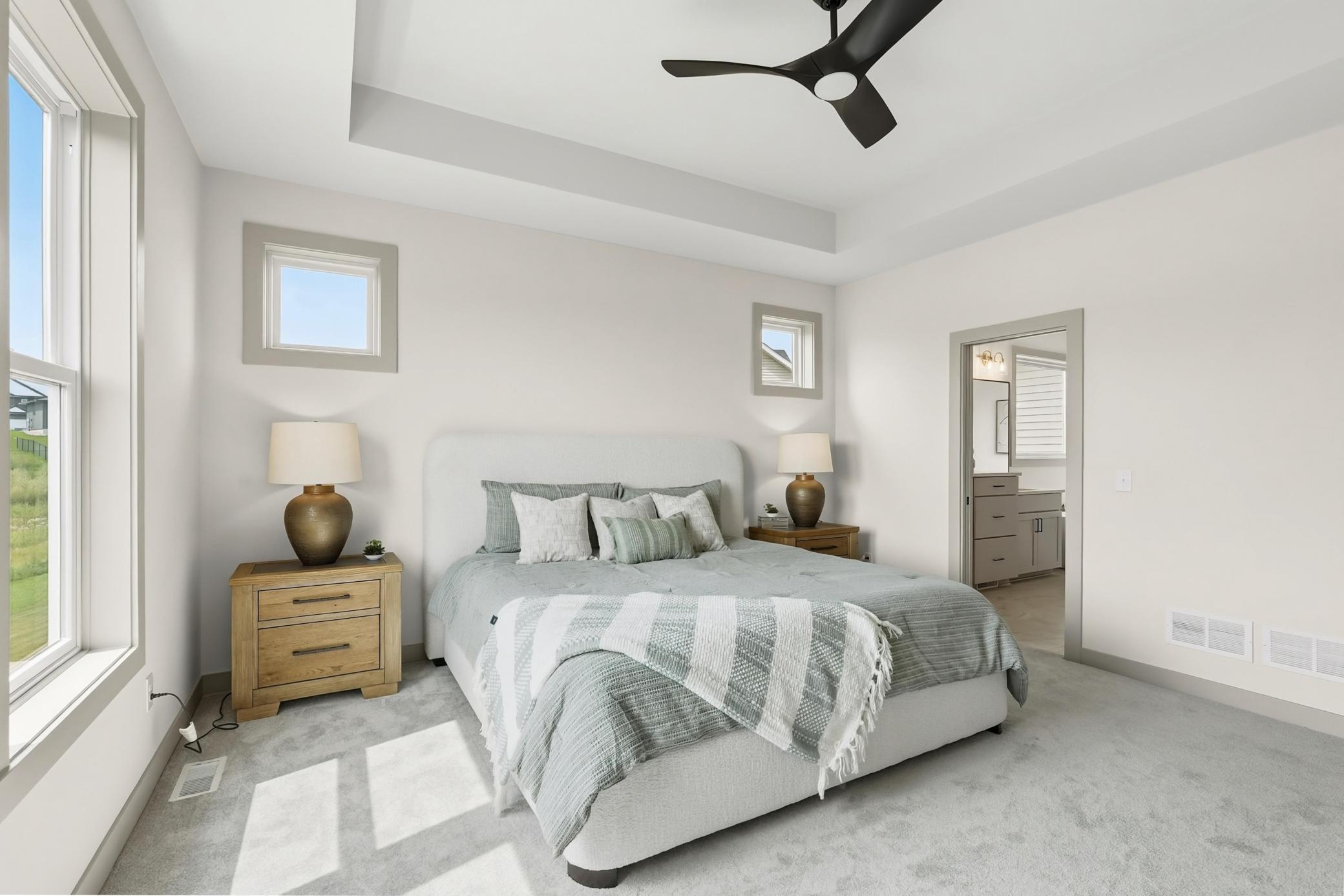Primary Suite (En-Suite Access)
Generously sized primary suite offering a comfortable layout, clean neutral paint palette, plush carpeting, and direct private entry into the en-suite bathroom & walkthrough closet to the laundry for easy living.