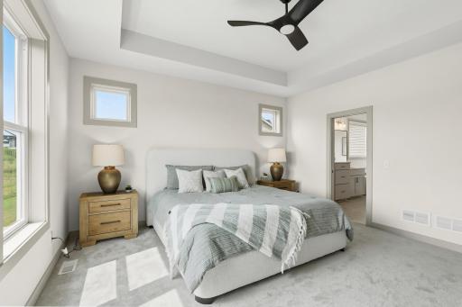 Primary Suite (En-Suite Access)
Generously sized primary suite offering a comfortable layout, clean neutral paint palette, plush carpeting, and direct private entry into the en-suite bathroom & walkthrough closet to the laundry for easy living.