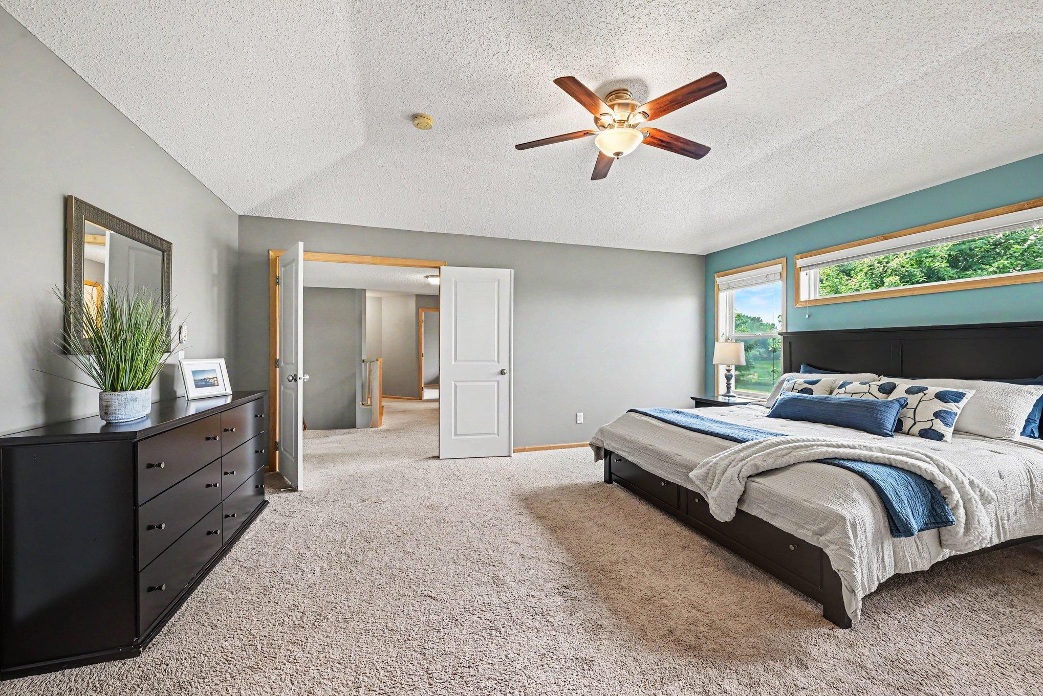 Primary bedroom suite on the upper level with double doors