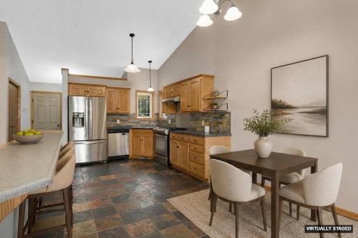 Beautiful open concept layout with slate tile floors in entry/kitchen/dining