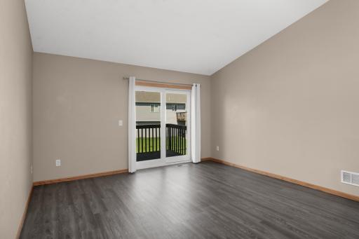 Living room with LVP flooring & access to the deck