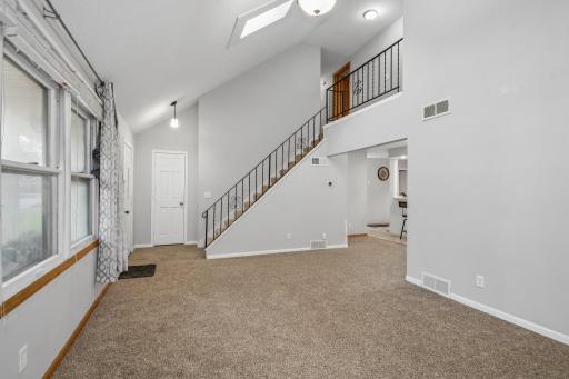 Living room with a view of the staircase leading up to the bedrooms.