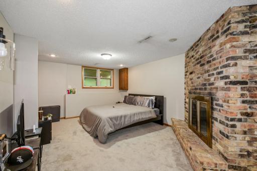 Partial view of the family room with brick fireplace - Flexible space for relaxing or entertaining!
