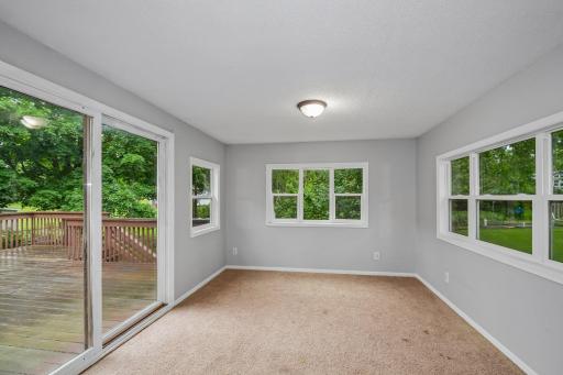 Sunroom with plenty of natural light and access to the deck.