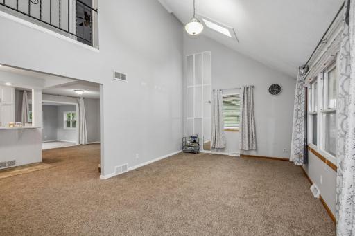 Living room with new carpet and a stunning vaulted ceiling!