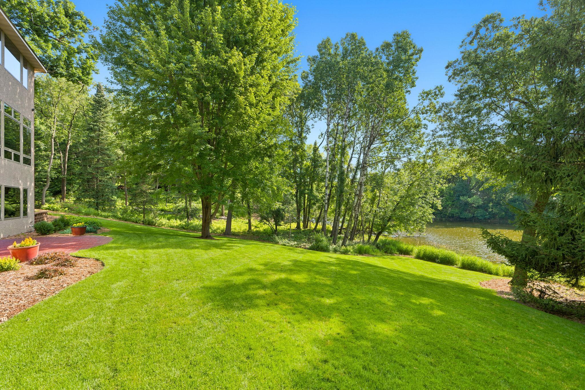 Large, gently sloped backyard with second stamped concrete patio.